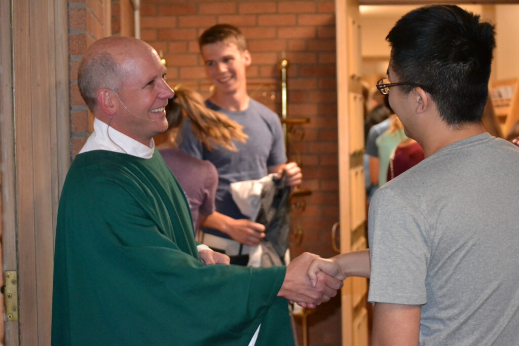 Fr rob shaking hands