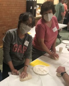 Mari Hardjito and Joan Edwards at the Bread of Life bread making event.